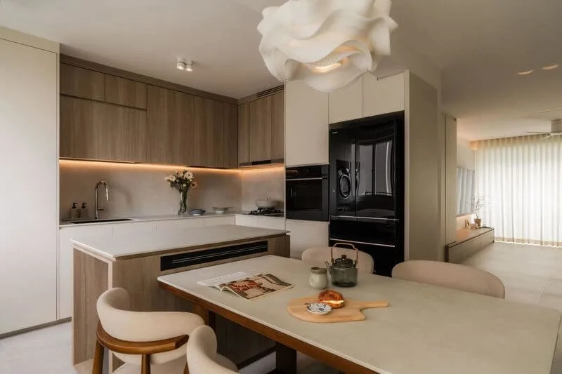 Singapore interior designer reviewing modern luxury home layouts, material samples, and design plans for a stylish living space.